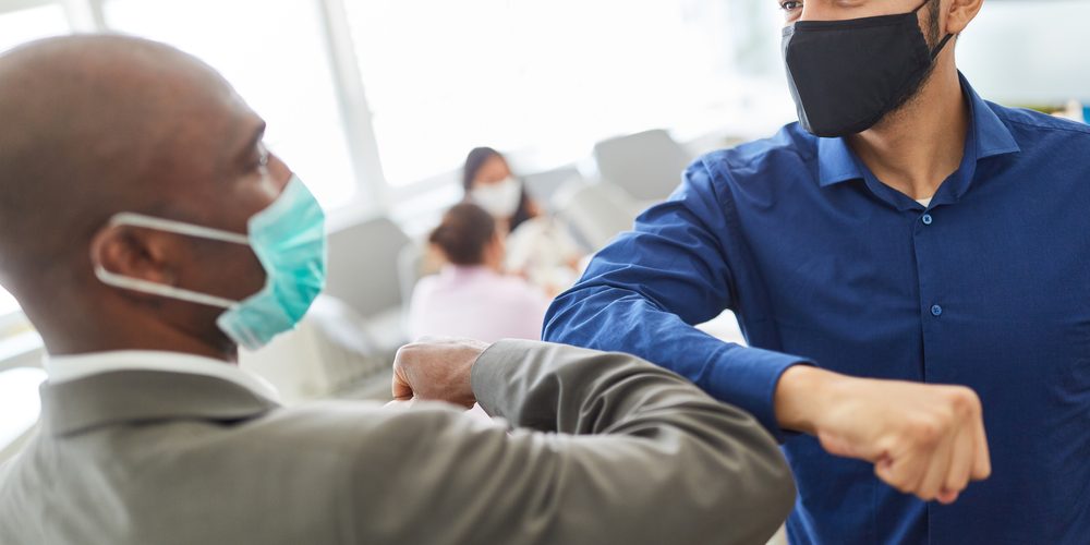 socially distanced elbow bump greeting employee wellbeing socially distanced elbow bump greeting employee wellbeing