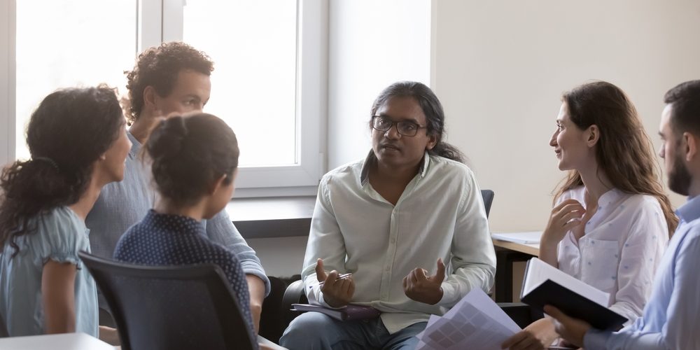 Why bosses need to share their lived experience Man sharing own lived experience with colleagues