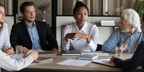 Age diverse workforce age diverse workforce sitting round a table.